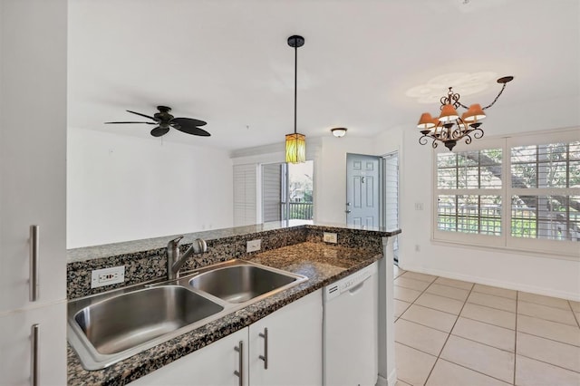 kitchen with a healthy amount of sunlight, white dishwasher, pendant lighting, and white cabinets