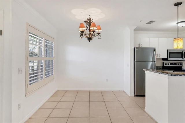 kitchen featuring hanging light fixtures, stainless steel appliances, crown molding, an inviting chandelier, and white cabinets