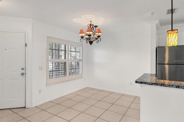 unfurnished dining area featuring ornamental molding, a chandelier, and light tile patterned floors