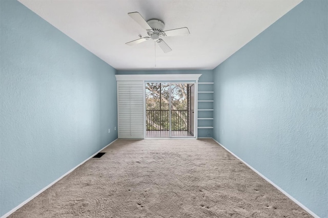 empty room featuring carpet floors and ceiling fan