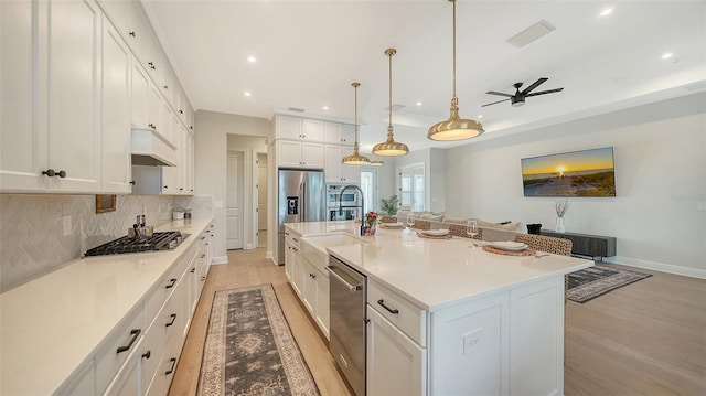 kitchen featuring a large island, light hardwood / wood-style flooring, white cabinets, and appliances with stainless steel finishes