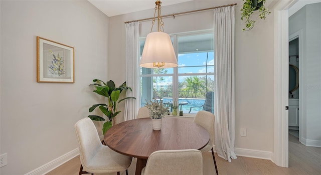 dining space with light hardwood / wood-style floors