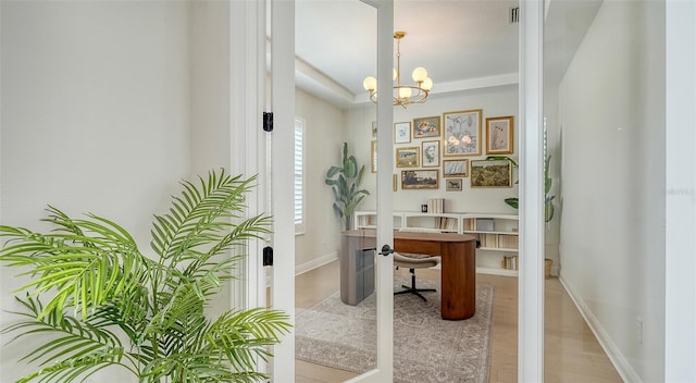 office area featuring a chandelier and wood-type flooring