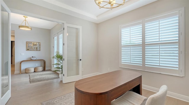 office featuring french doors, light hardwood / wood-style flooring, and an inviting chandelier