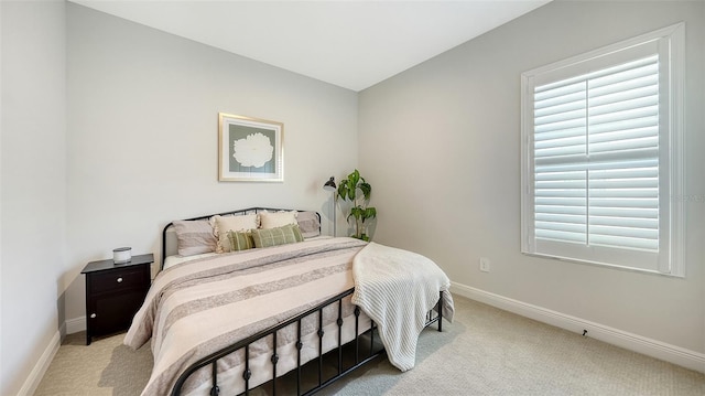 carpeted bedroom featuring multiple windows