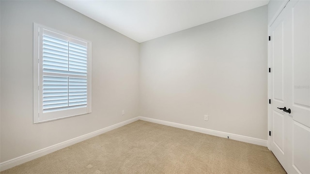 carpeted spare room with a healthy amount of sunlight