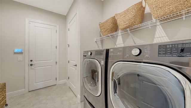 clothes washing area with washing machine and clothes dryer