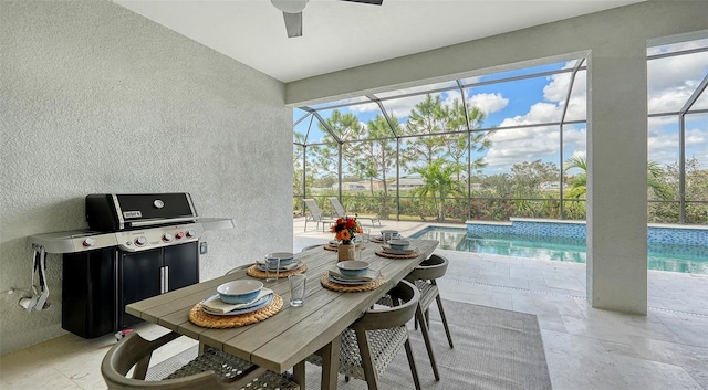 interior space with grilling area, glass enclosure, and ceiling fan