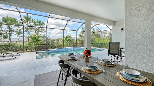 view of swimming pool with a patio area and glass enclosure