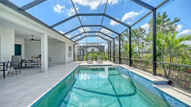 view of pool featuring a patio, ceiling fan, and a lanai