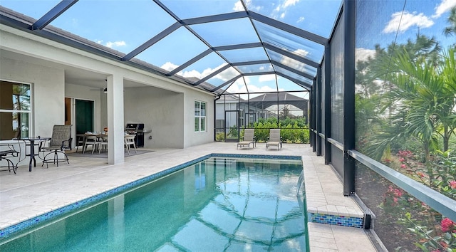 view of pool featuring a grill, ceiling fan, a patio, and a lanai