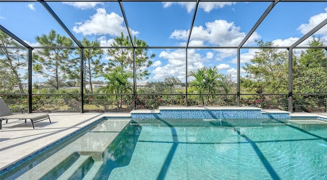 view of pool with a patio and a lanai