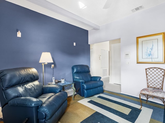 carpeted living room with ceiling fan