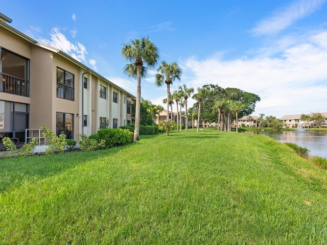 exterior space featuring a yard and a water view