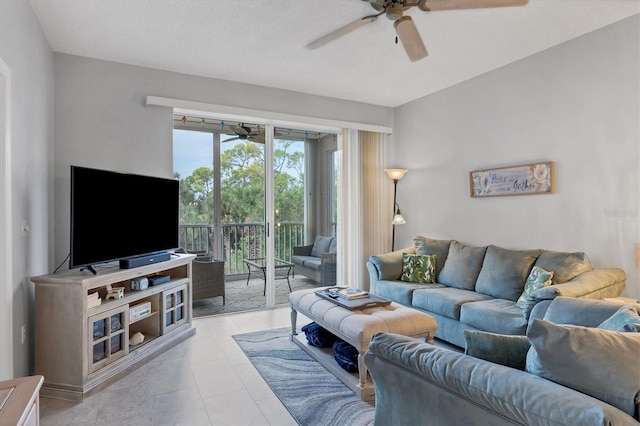 tiled living room featuring ceiling fan and a textured ceiling