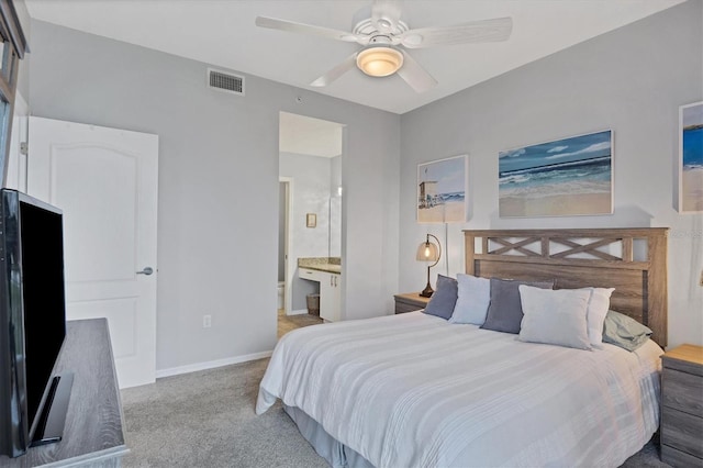 carpeted bedroom featuring connected bathroom and ceiling fan