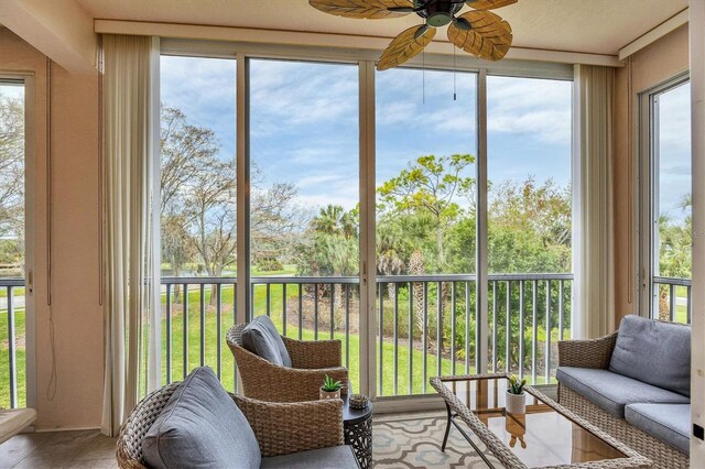 sunroom featuring ceiling fan