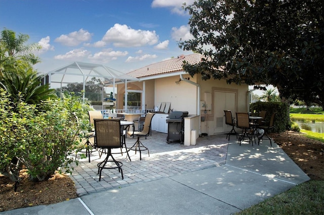 view of patio / terrace with glass enclosure and area for grilling