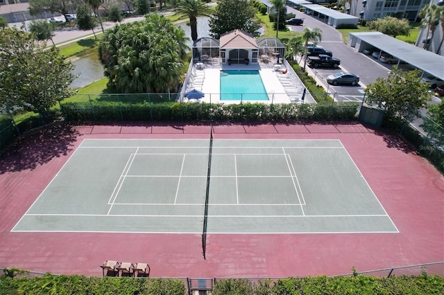 view of sport court with a community pool