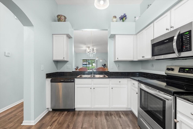 kitchen with appliances with stainless steel finishes, white cabinetry, and sink