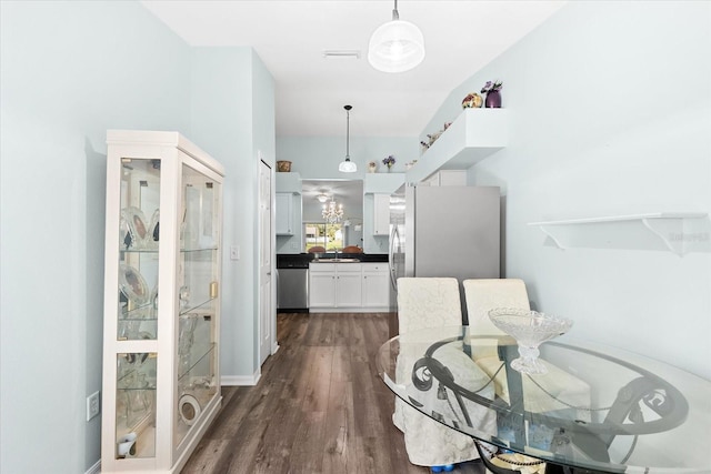 dining area with sink and dark wood-type flooring