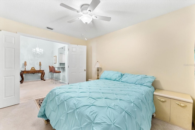 bedroom featuring light carpet, a textured ceiling, and ceiling fan with notable chandelier