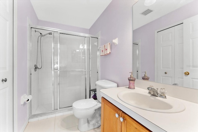 bathroom with vanity, toilet, tile patterned floors, and walk in shower