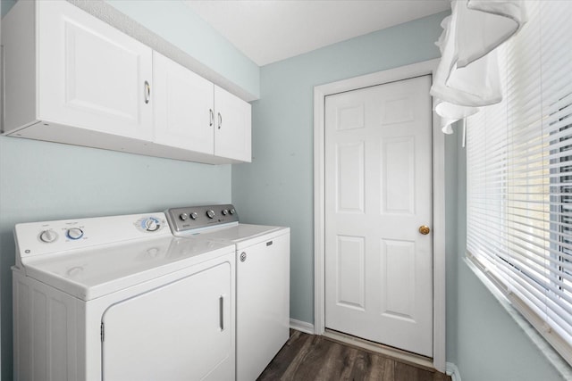 washroom with cabinets, dark hardwood / wood-style floors, and washing machine and dryer