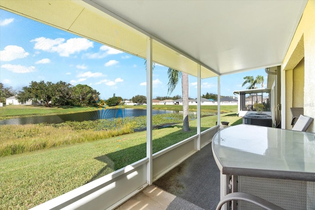 sunroom / solarium with a water view