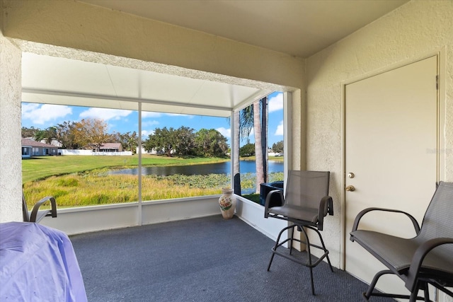 sunroom / solarium with a water view