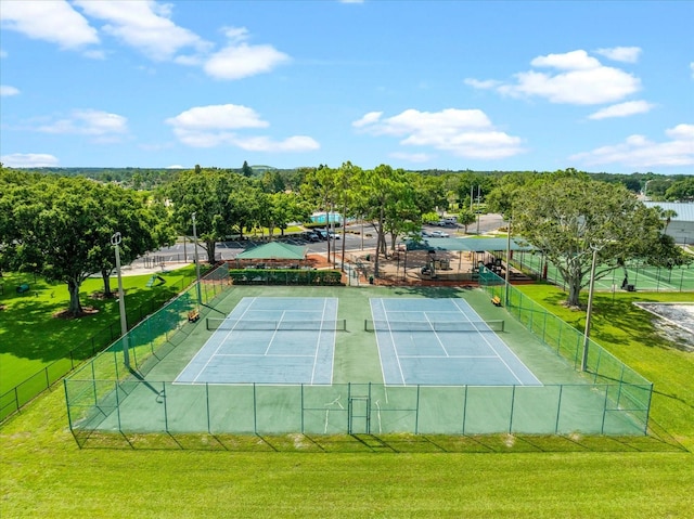 view of sport court with a yard