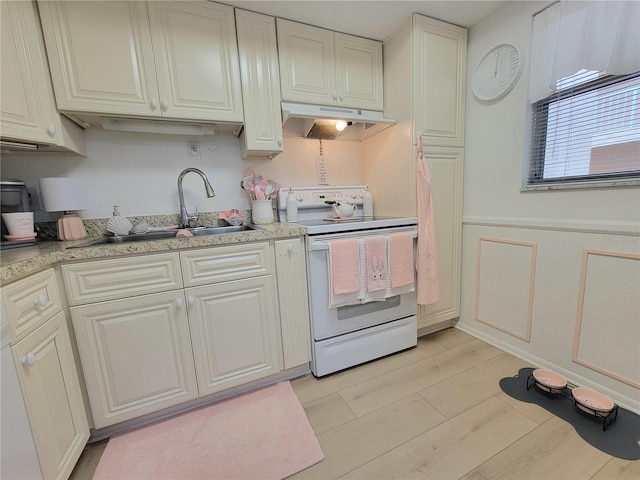 kitchen with light wood-type flooring, sink, and white range with electric stovetop