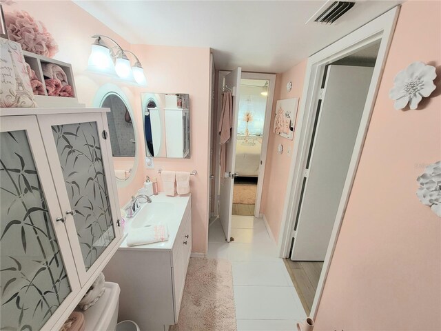 bathroom featuring tile patterned floors, vanity, and toilet