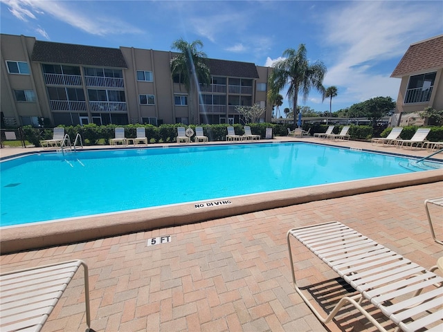 view of swimming pool featuring a patio