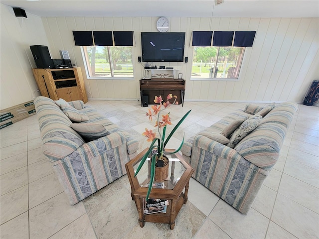 tiled living room featuring wooden walls