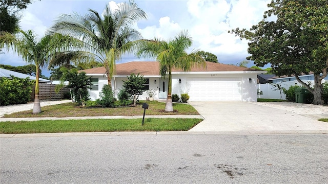 view of front of home with a front yard and a garage