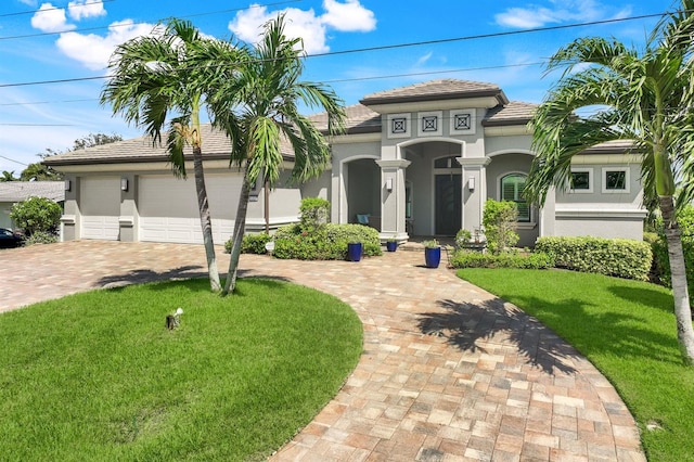 mediterranean / spanish home with a front yard and a garage