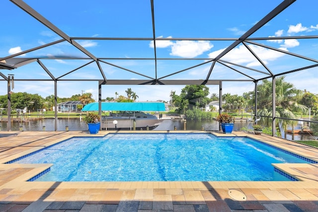 view of swimming pool featuring a water view, a patio, and glass enclosure