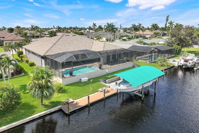 view of dock with a water view, glass enclosure, a patio, and a lawn