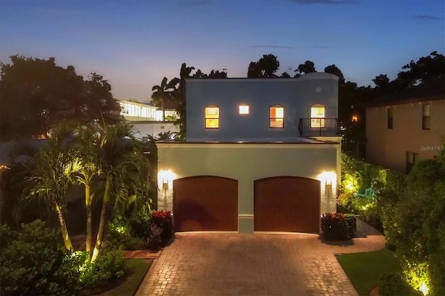 view of front of house with a balcony and a garage