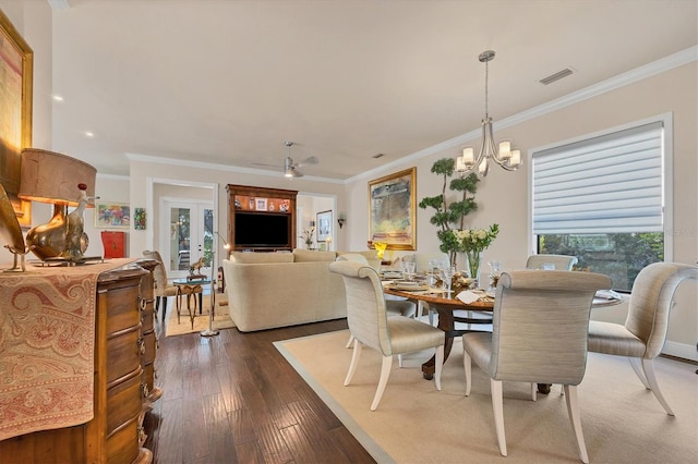 dining space featuring ornamental molding, a chandelier, plenty of natural light, and dark hardwood / wood-style floors