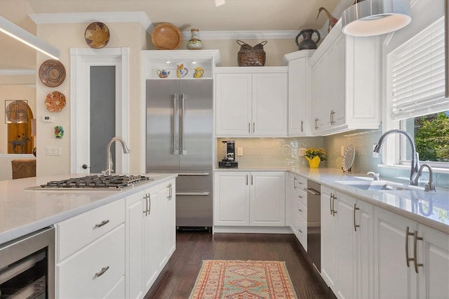 kitchen with wine cooler, white cabinetry, dark wood-type flooring, sink, and stainless steel appliances