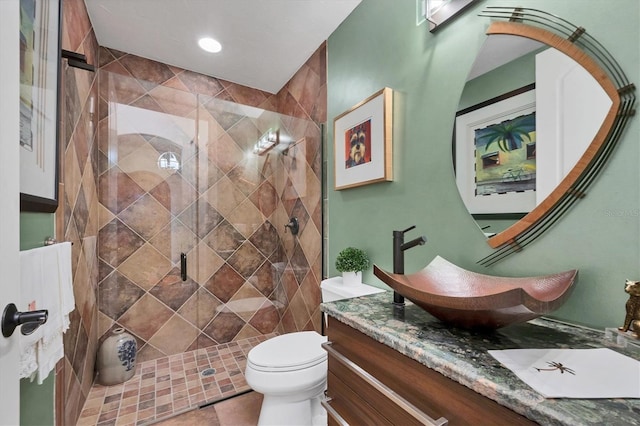 bathroom with vanity, toilet, tile patterned floors, and walk in shower