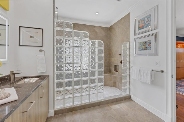 bathroom featuring vanity, ornamental molding, tiled shower, and hardwood / wood-style floors