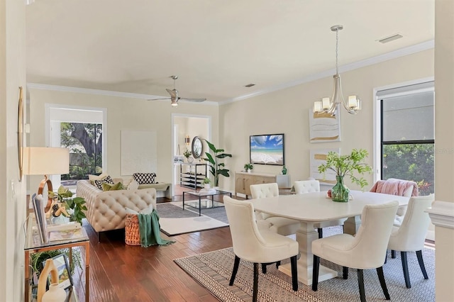 1884 Grove St, Sarasota, FL 34239 - dining room featuring dark wood-style flooring, a chandelier, ornamental molding, and a ceiling fan