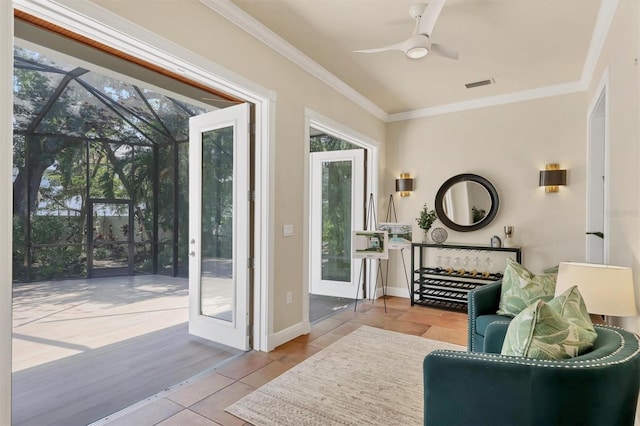 1884 Grove St, Sarasota, FL 34239 - doorway to outside featuring ceiling fan, plenty of natural light, crown molding, a sunroom, and tile patterned floors