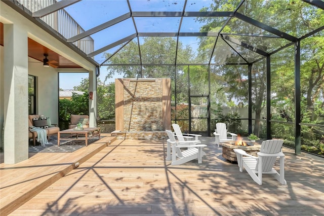 1884 Grove St, Sarasota, FL 34239 - view of patio / terrace with an outdoor fire pit, a lanai, ceiling fan, and an outdoor stone fireplace