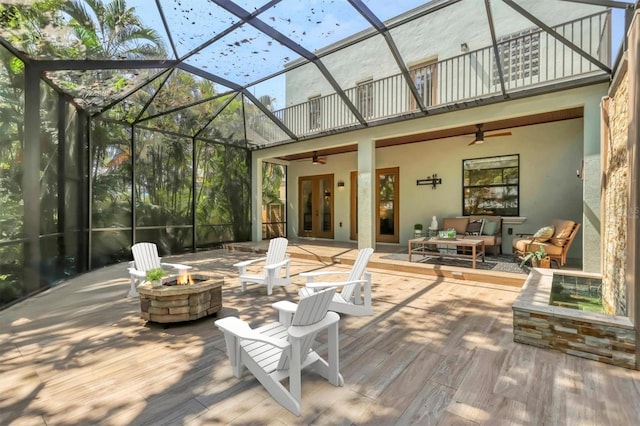 1884 Grove St, Sarasota, FL 34239 - wooden deck with a ceiling fan, an outdoor living space with a fire pit, and glass enclosure
