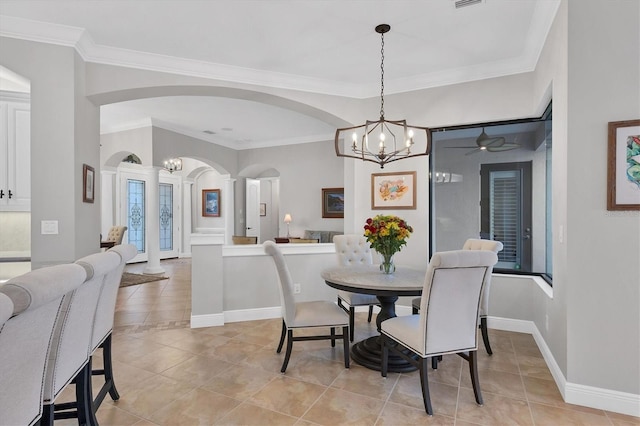 dining room featuring light tile patterned floors, ceiling fan with notable chandelier, and ornamental molding