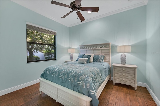 bedroom with ornamental molding, dark hardwood / wood-style flooring, and ceiling fan